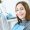 A woman is smiling with white and healthy teeth while sitting in a dental chair. Doctor dentist and happy patient in the office of a medical clinic.